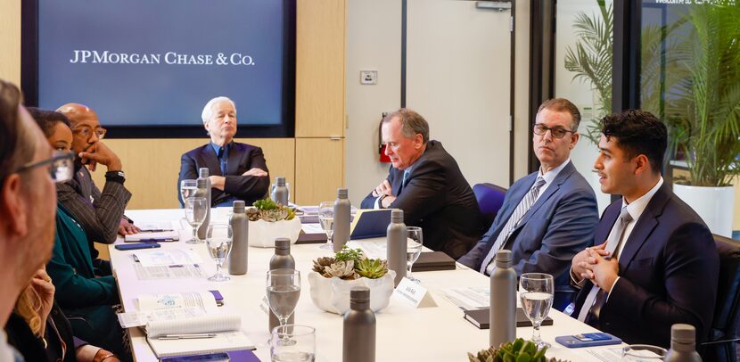 JPMorgan Chase CEO Jamie Dimon (center) listens to Southern Methodist University student...