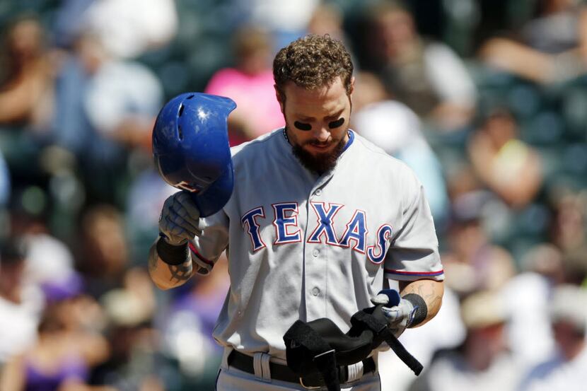 FILE - in this July 22, 2015, file photo, Texas Rangers' Josh Hamilton reacts after striking...