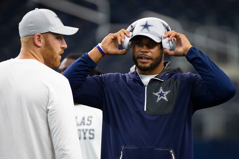 Dallas Cowboys quarterback Dak Prescott (right) talks with quarterback Cooper Rush before a...