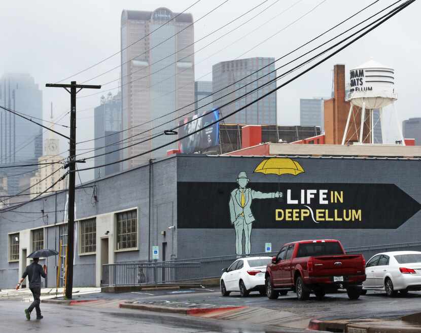 An appropriate sign on a Deep Ellum building is pictured with part of the downtown Dallas...