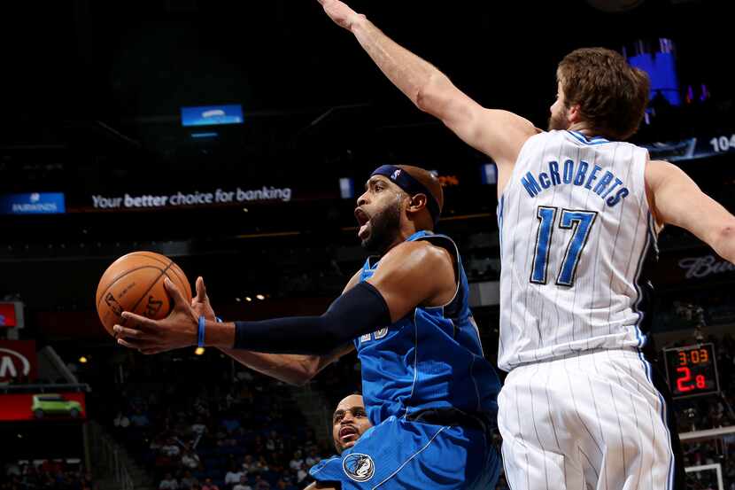 Orlando Magic forward Josh McRoberts guards Dallas Mavericks' Vince Carter during an NBA...