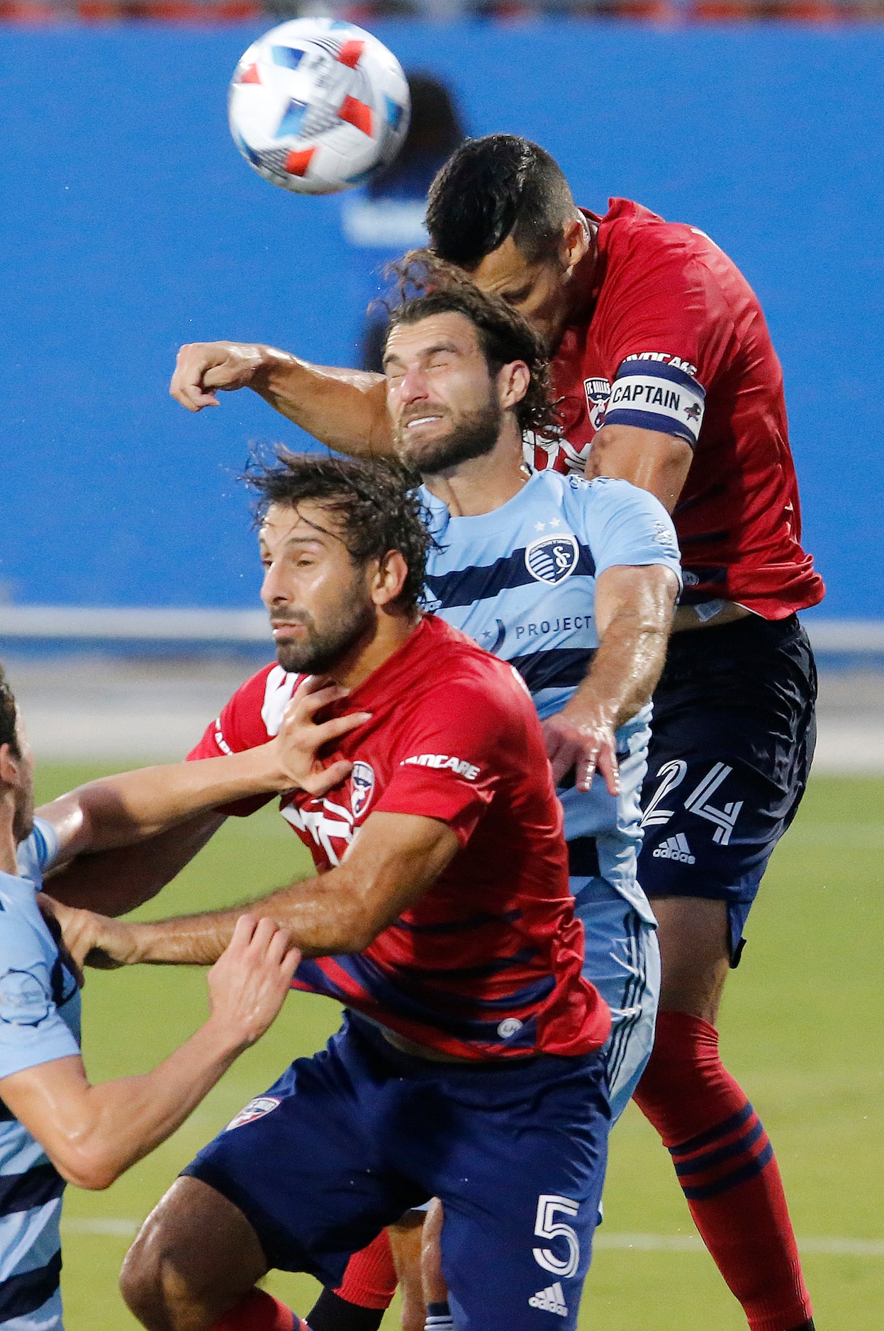 FC Dallas defender Matt Hedges (24) gets a header over Sporting Kansas City midfielder...