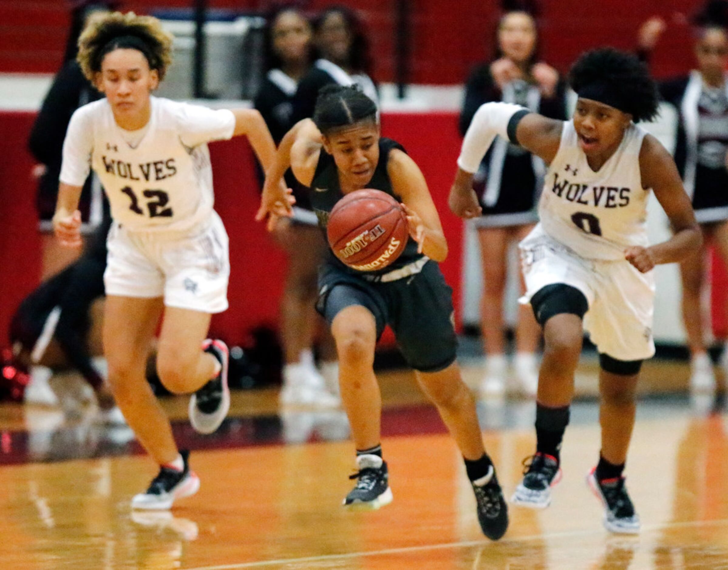 After stealing the basketball, The Colony High School guard Aariyah Cotto (4) takes off with...