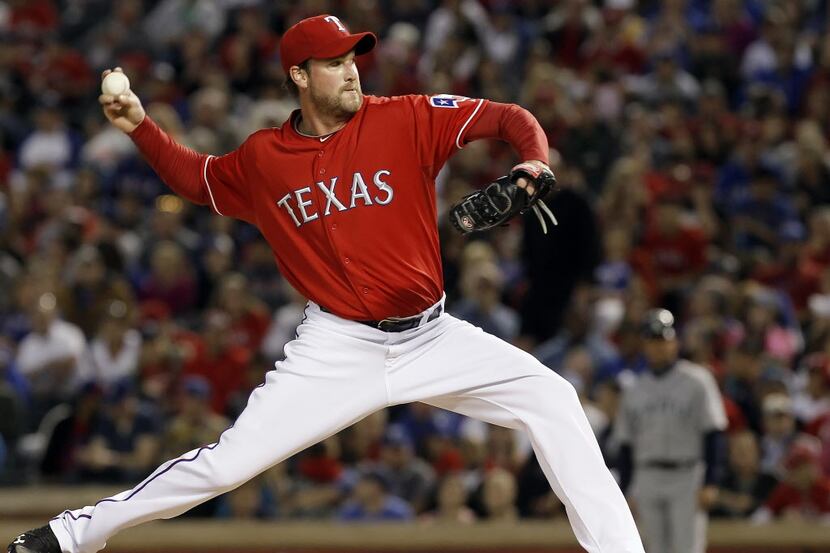 Texas Rangers relief pitcher Derek Lowe throws in the fifth inning of a baseball game...