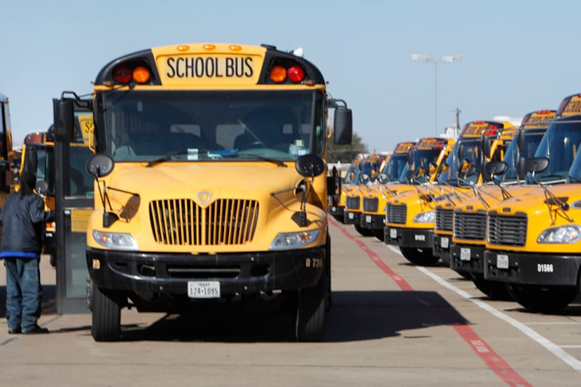 A Dallas County Schools bus driver prepares to leave Monday from one of four bus depots...