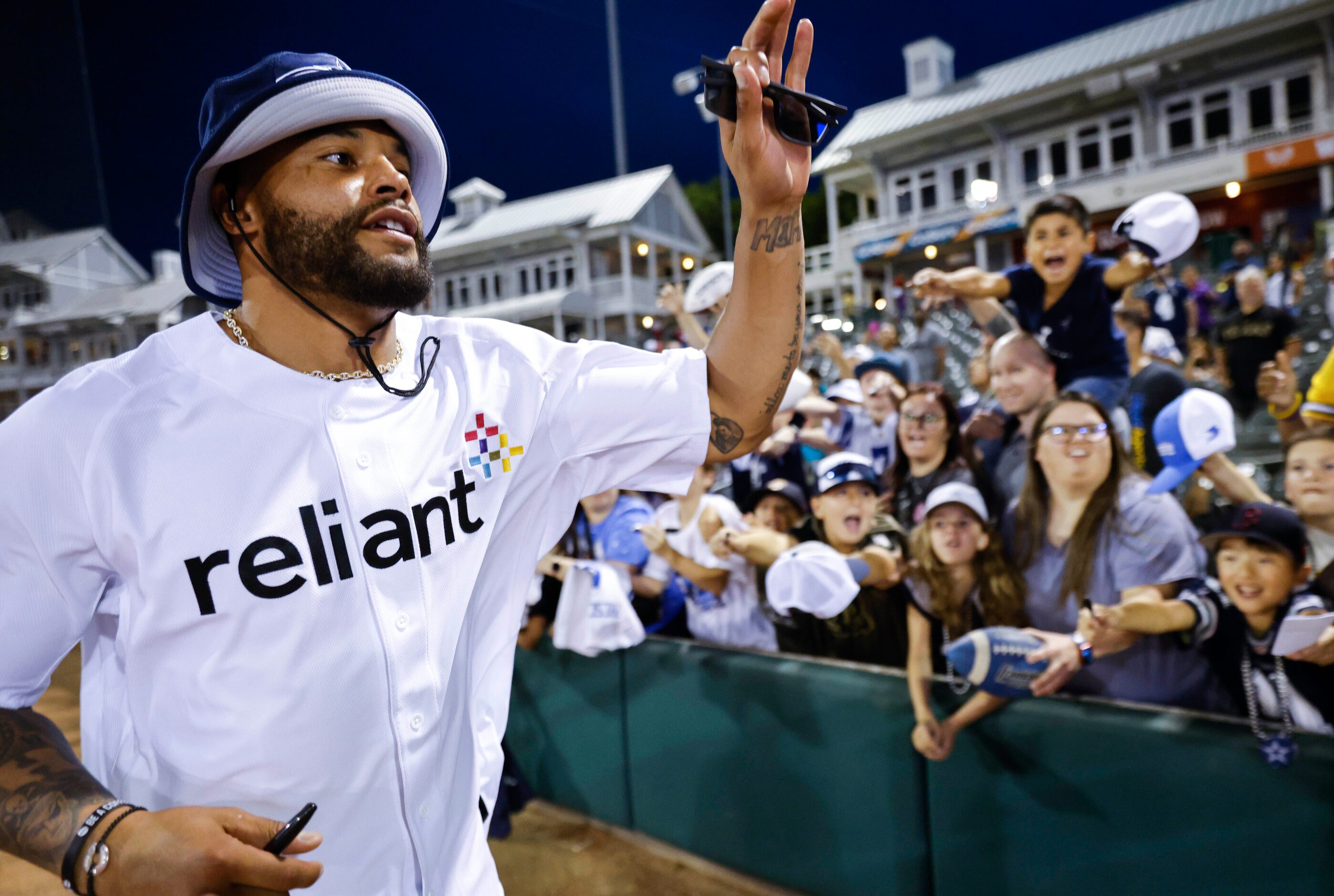 Dallas Cowboys QB Dak Prescott cheers as he passes by the crowd  during annual home run...