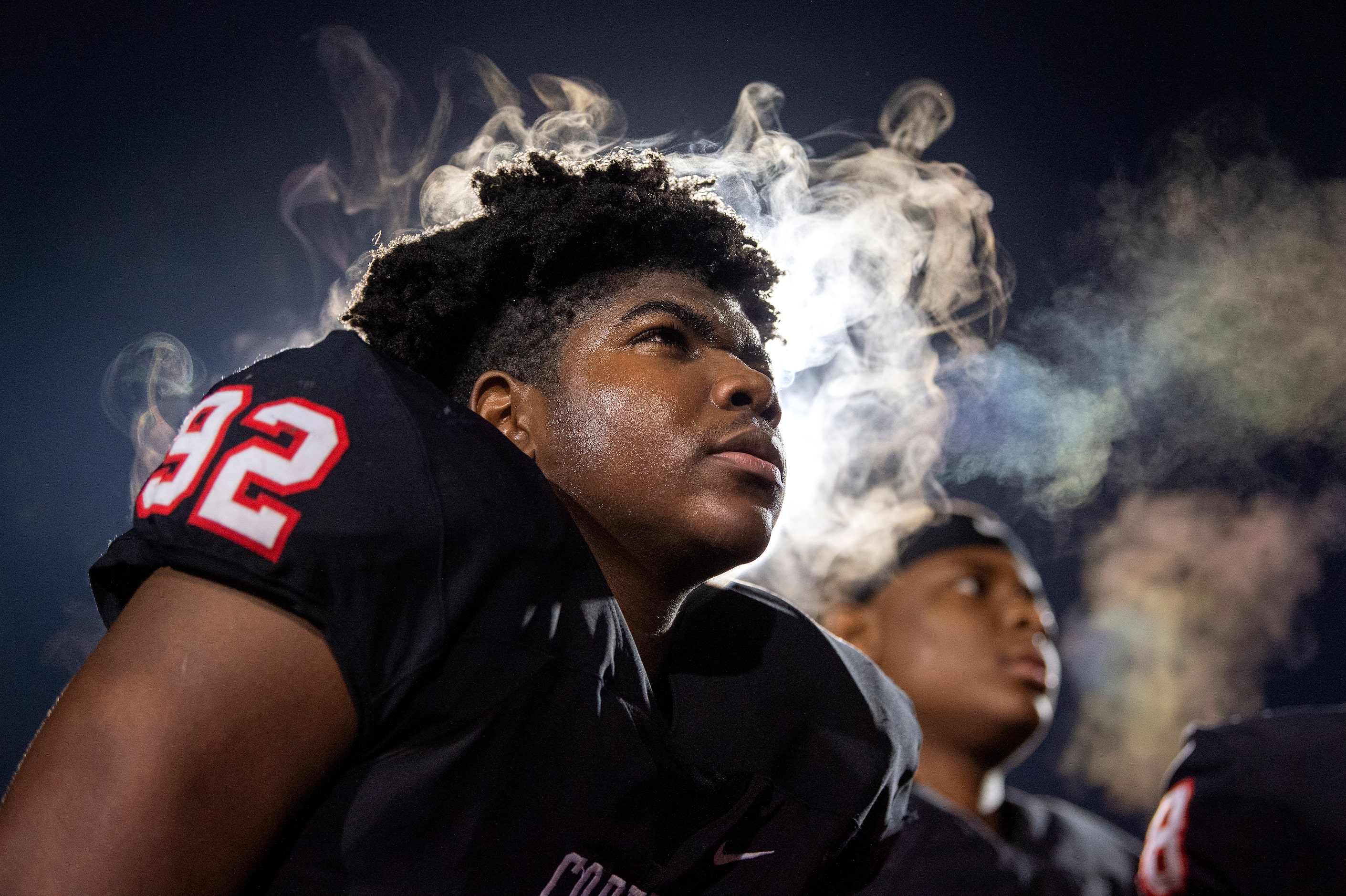 Steam rises from the head of Coppell junior defensive lineman Simi Ncube-Socks (92) as he...