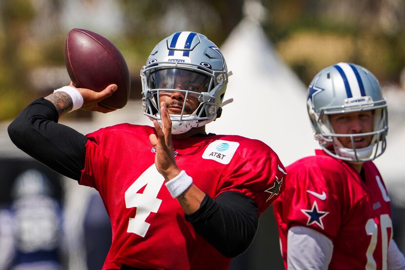 Dallas Cowboys quarterback Dak Prescott (4) throws a pass as quarterback Cooper Rush (10)...