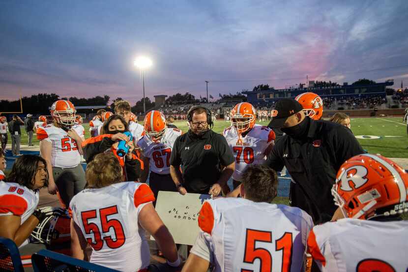 Rockwall offensive line coach Rusty Brackett, center, instructs his players on the sidelines...