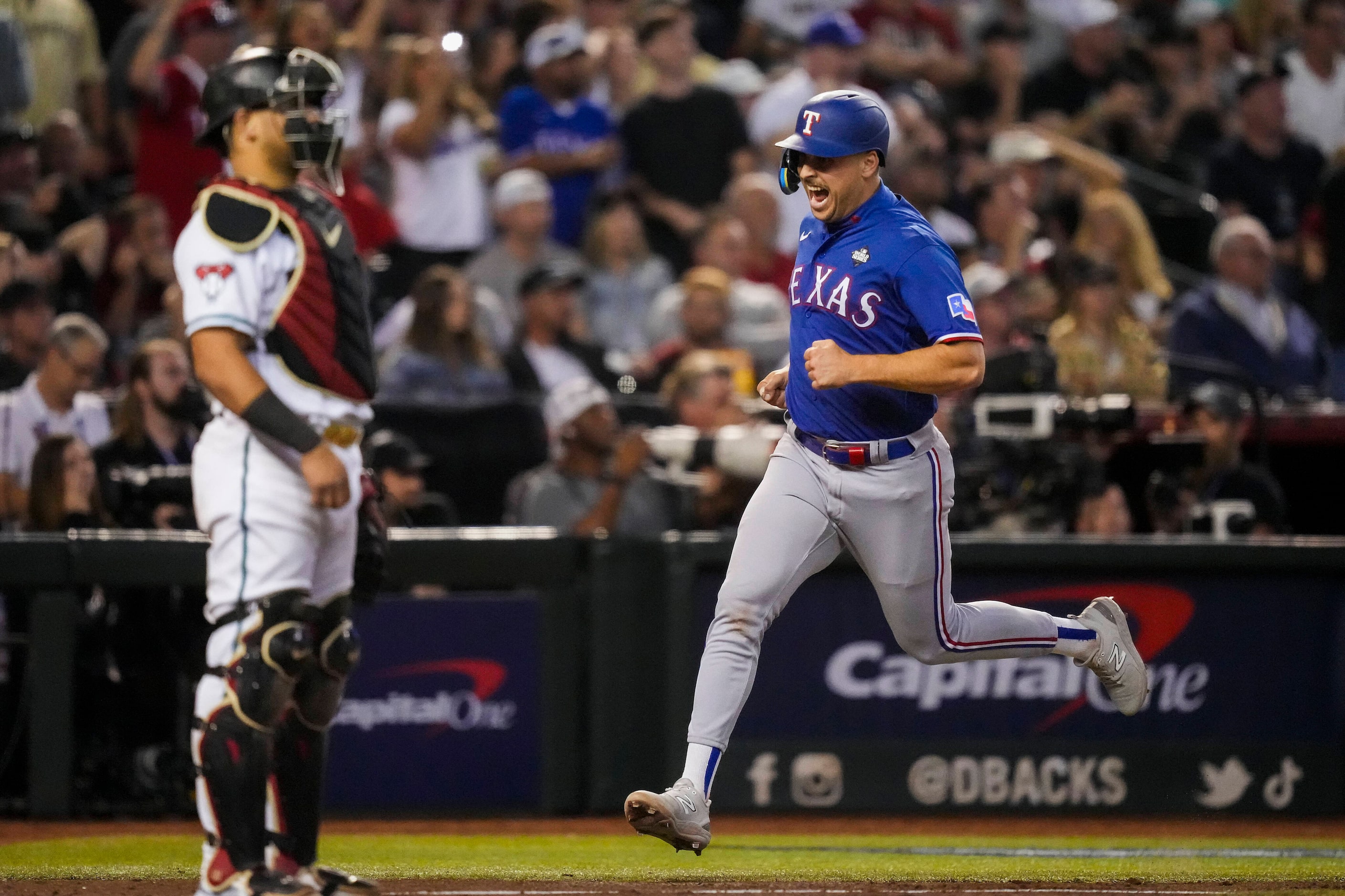 Texas Rangers first baseman Nathaniel Lowe scores on a single by Jonah Heim during the ninth...