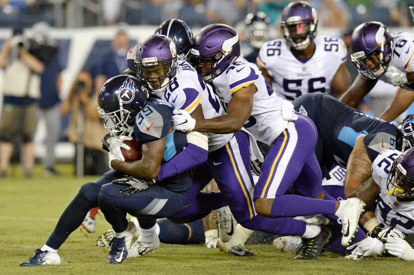 FILE - Tennessee Titans running back Dalyn Dawkins (39) is stopped by Minnesota Vikings...