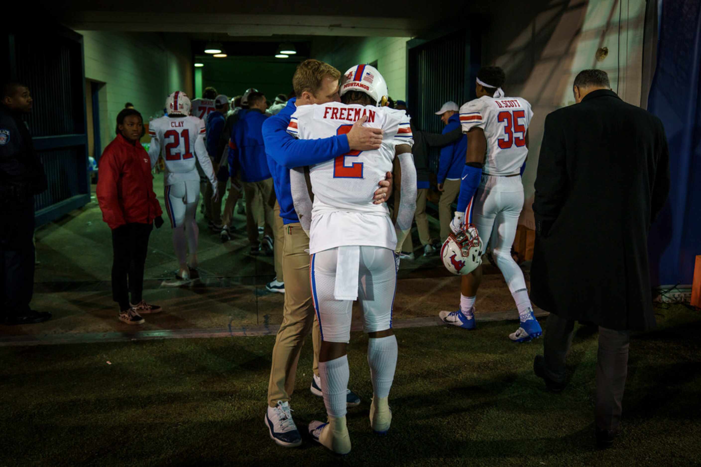 SMU running back Ke'Mon Freeman (2) is consoled by a coach as the Mustangs leave the field...