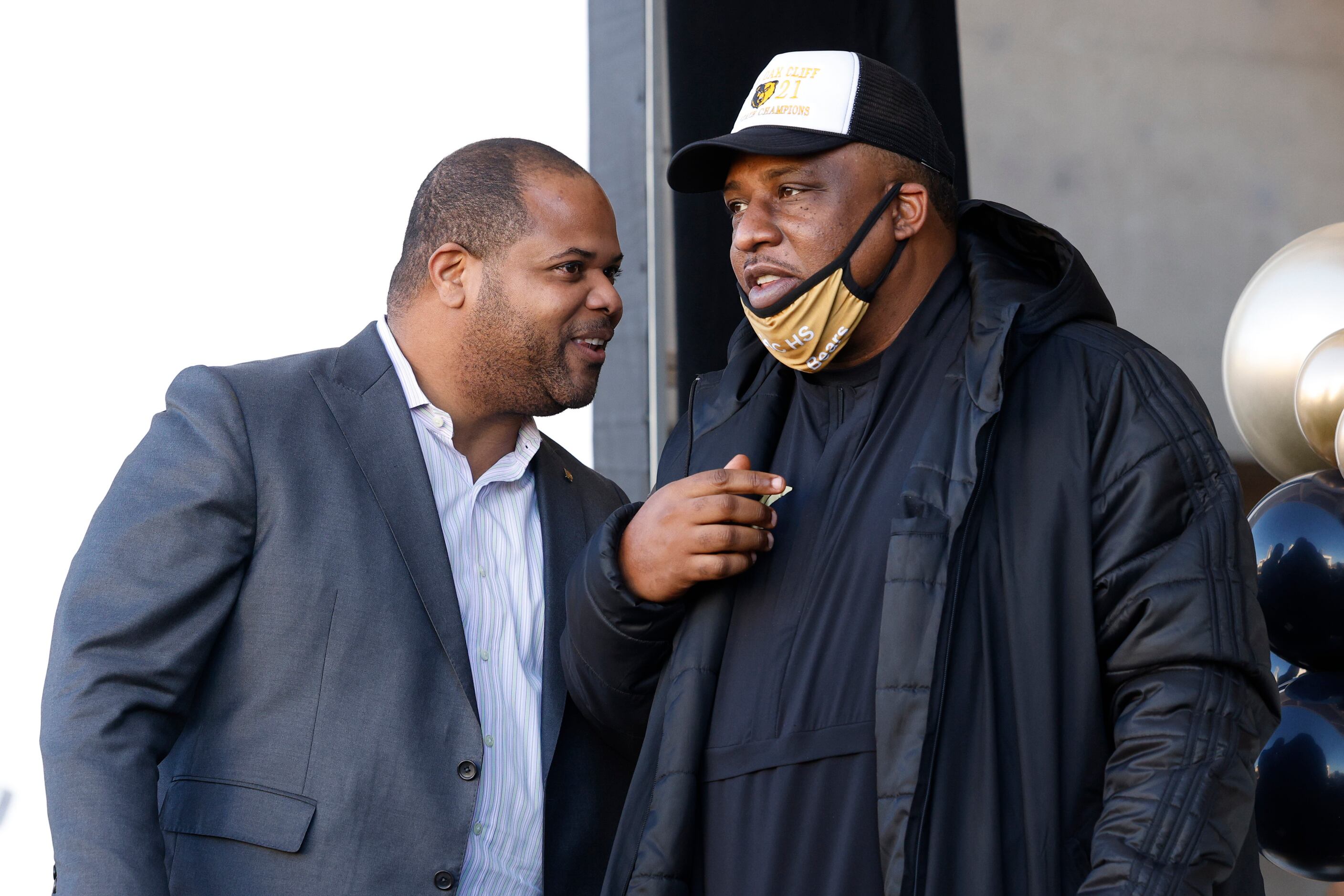 Dallas Mayor Eric Johnson greets South Oak Cliff head coach Jason Todd during a ceremony...