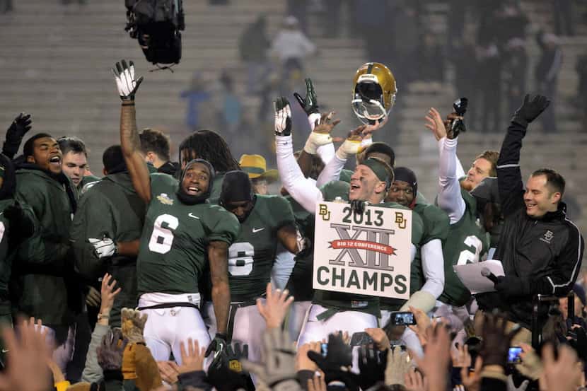 Baylor players celebrate after winning the Big 12 title by defeating Texas 30-10 in an NCAA...