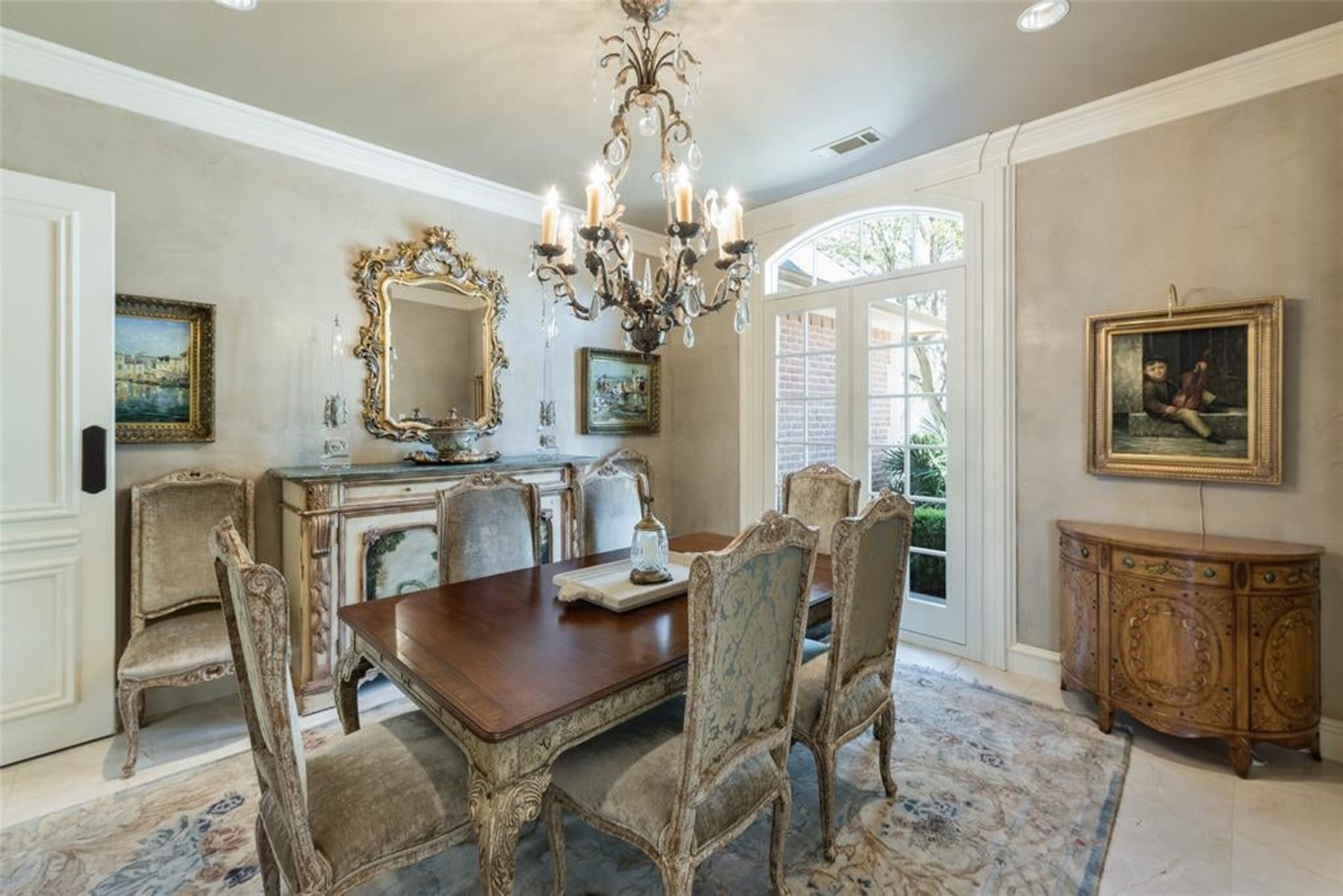 Off the foyer is the large formal dining room with a chandelier.