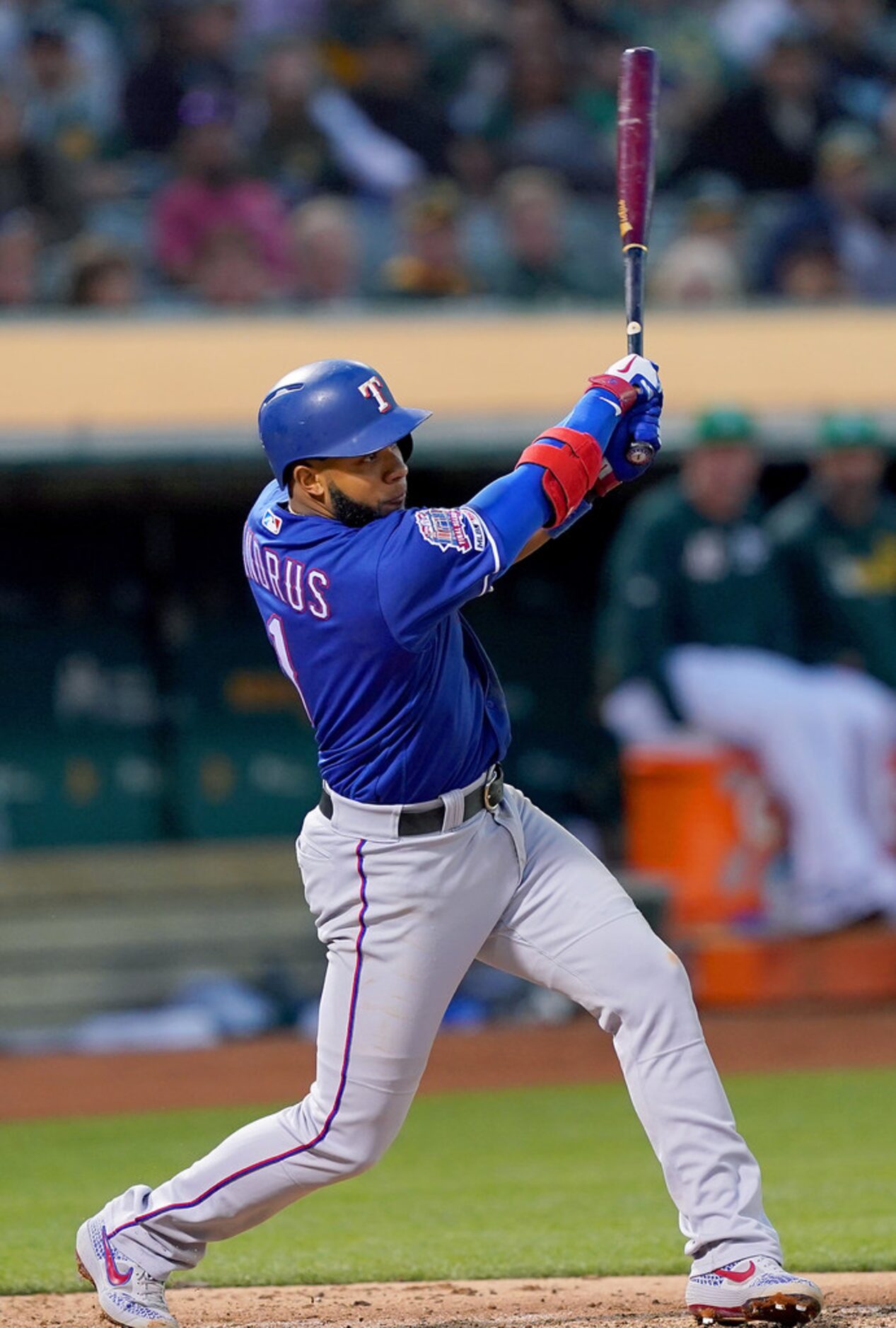 OAKLAND, CA - JULY 25:  Elvis Andrus #1 of the Texas Rangers hits a sacrifice fly scoring...