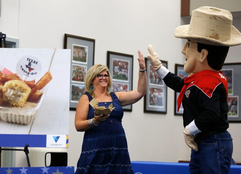 Johnna McKee high-fives Little Big Tex. Her family's Fernie's Hoppin' John Cake is stuffed...