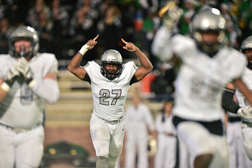 Guyer senior defensive end Ben Nwiba (27) reacts after the Wildcats stop a Southlake Carroll...
