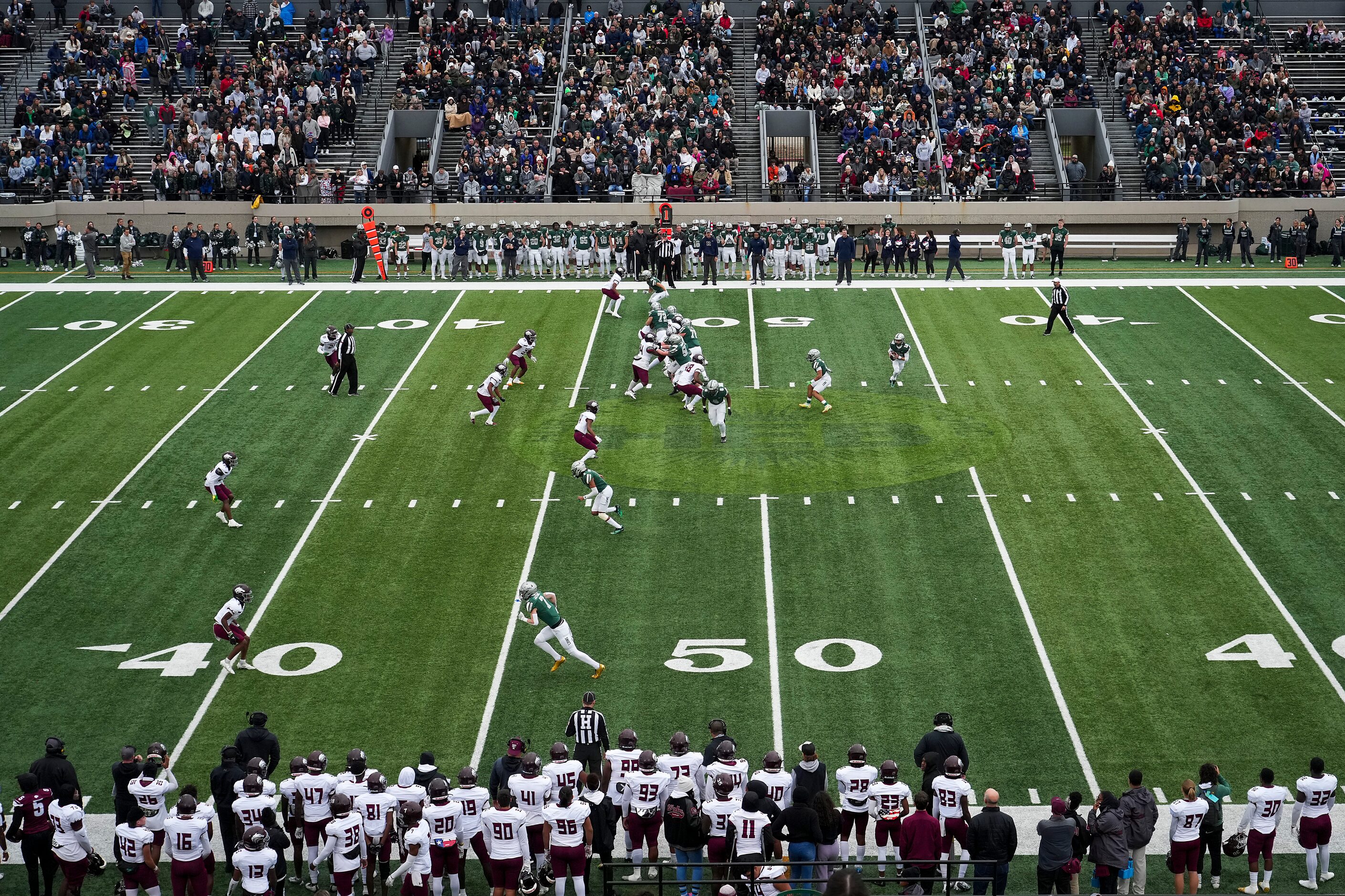 Frisco Reedy quarterback Caleb Deal (12) rolls out to pass against Mansfield Timberview...