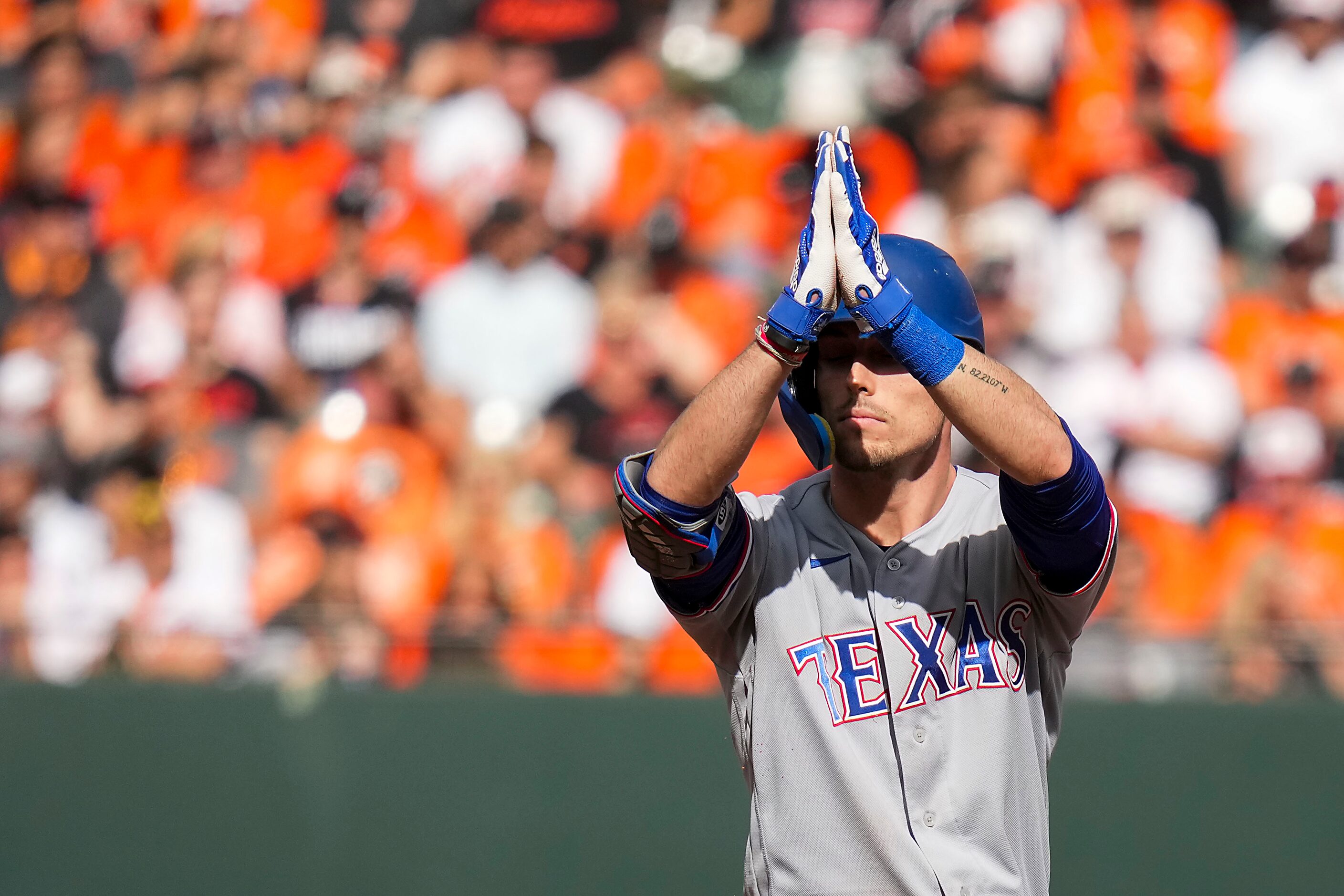 Texas Rangers left fielder Evan Carter celebrates after reaching second base with a double...