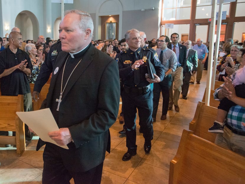 Rev. Edward J. Burns, left, bishop of the Roman Catholic Diocese of Dallas is followed a...
