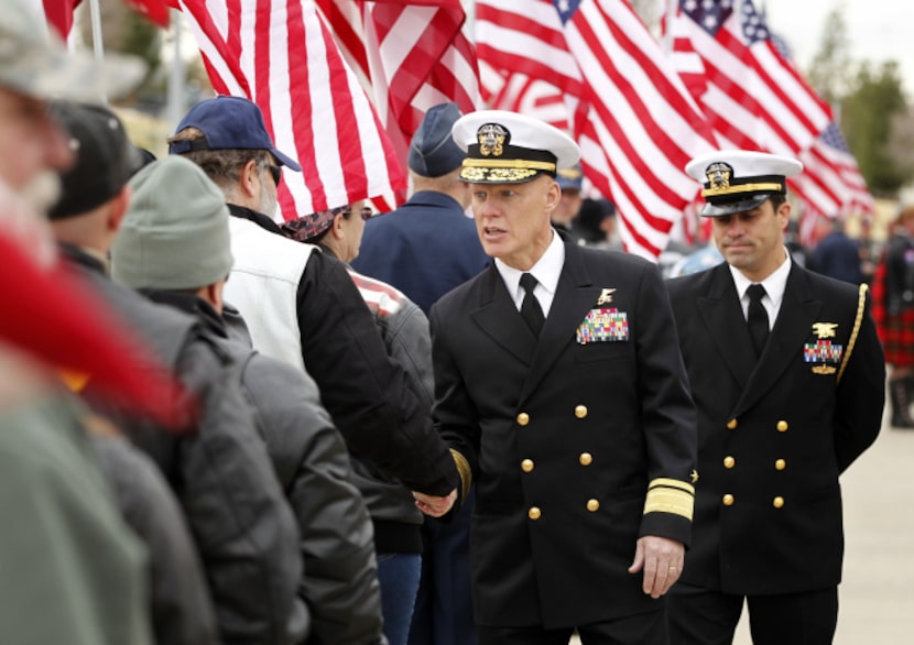 A military leader shakes hands with members of the Patriot Guard Riders before a memorial...