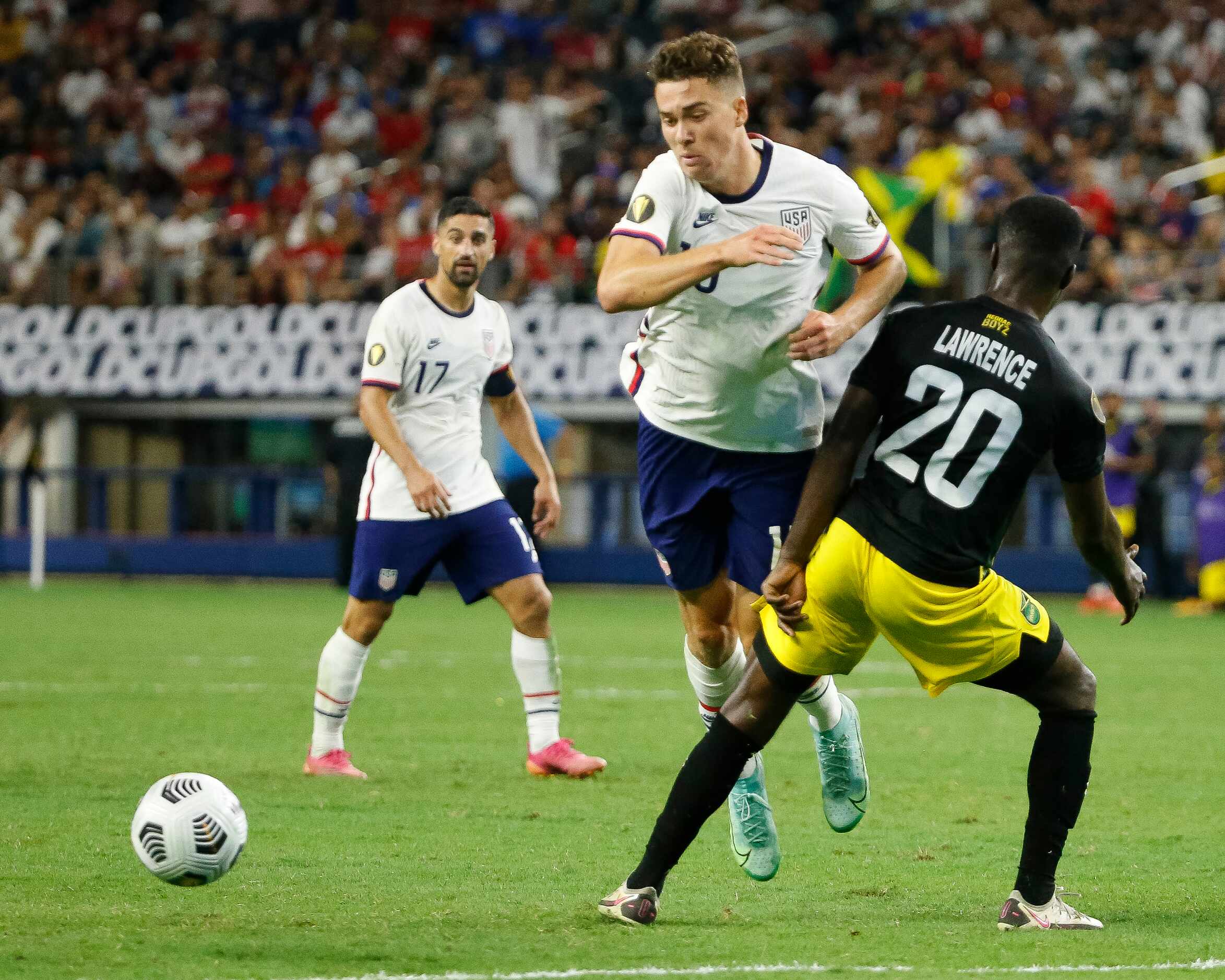 USA forward Matthew Hoppe (13) is brought down by Jamaica defender Kemar Lawrence (20)...