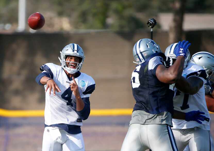 Dallas Cowboys quarterback Dak Prescott (4) throws a pass during the afternoon practice at...