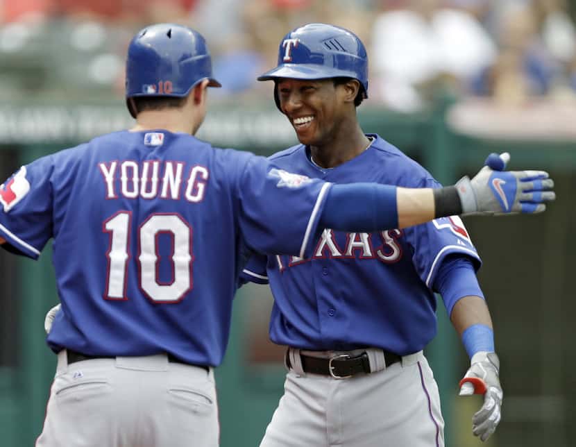 Texas Rangers' Jurickson Profar, right, is greeted by Michael Young (10) after a solo home...