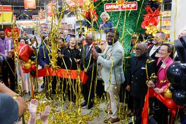 Streamers fall to the ground after a ribbon cutting ceremony for Joe V’s Smart Shop along...