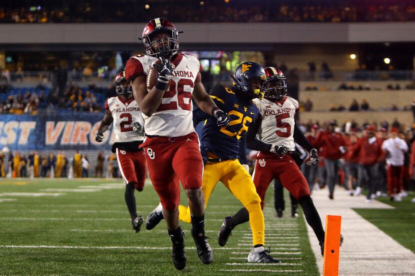 MORGANTOWN, WV - NOVEMBER 23:  Kennedy Brooks #26 of the Oklahoma Sooners rushes for a 68...