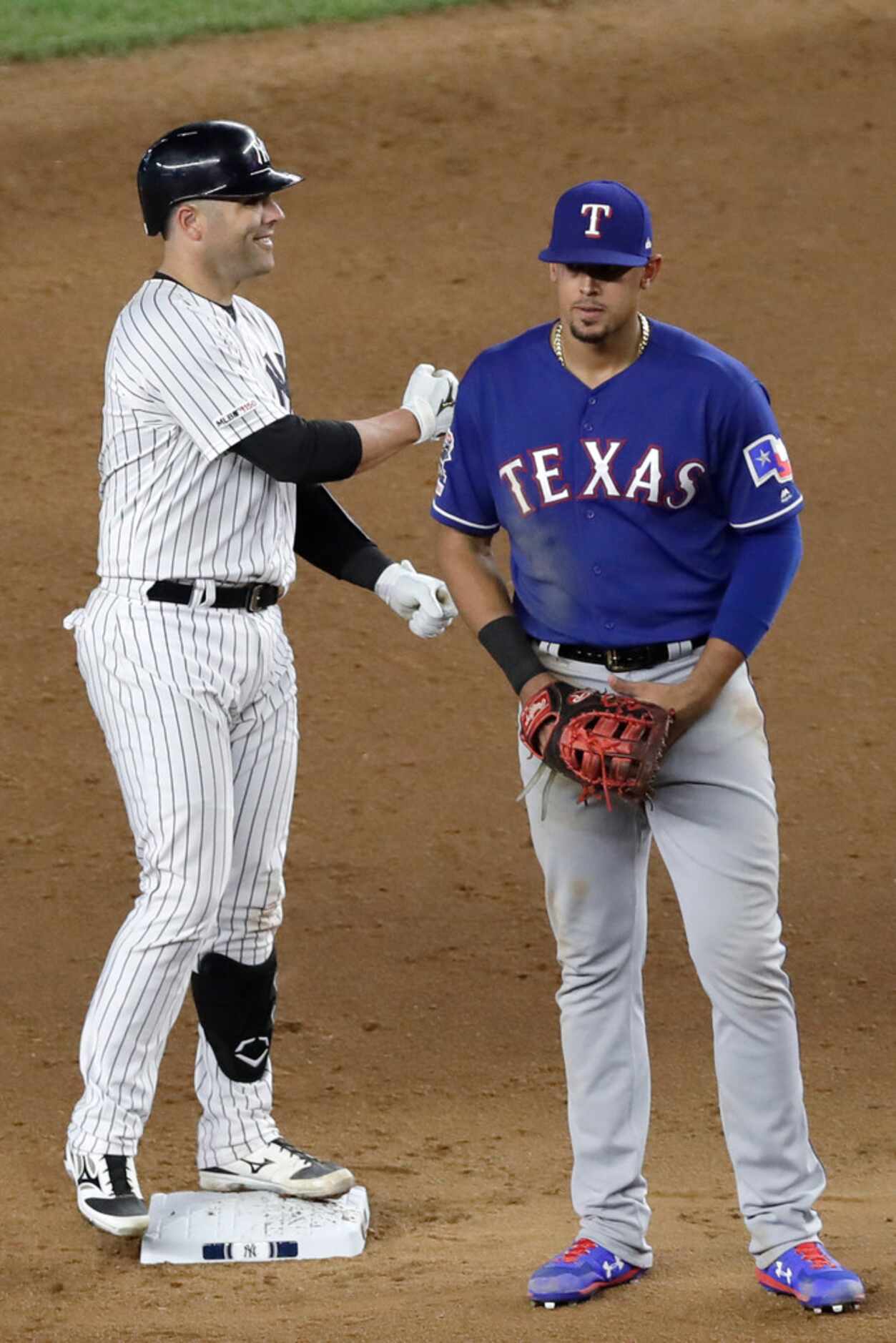 New York Yankees' Austin Romine mimics teammate Brett Gardner banging his bat on the dugout...
