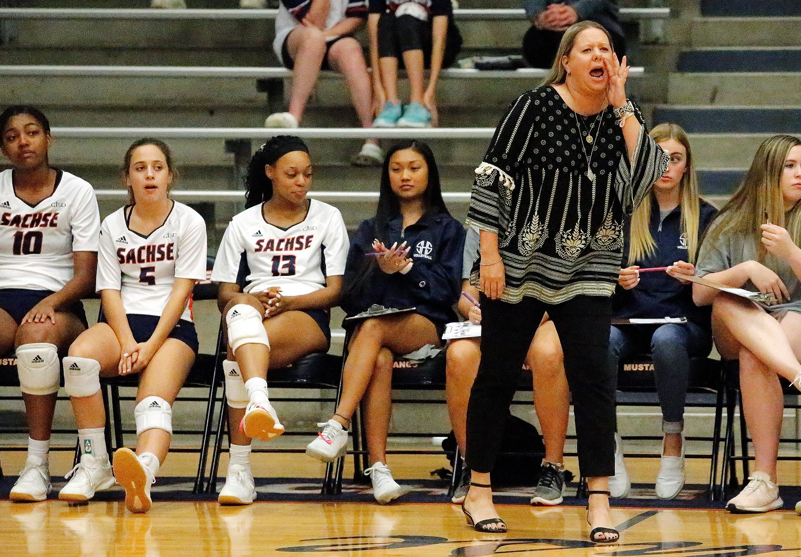 Sachse High School head coach Rikki Jones shouts instruction to her players during game one...