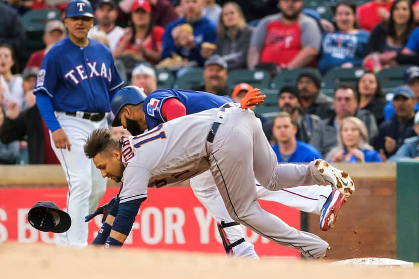 Texas Rangers outfielder Nomar Mazara collides with Houston Astros first baseman Yuli...