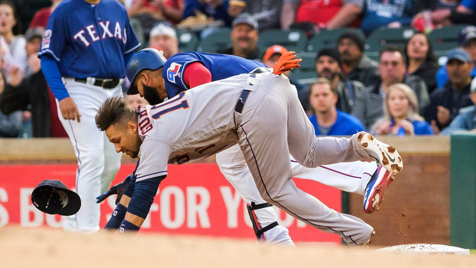 Texas Rangers outfielder Nomar Mazara collides with Houston Astros first baseman Yuli...