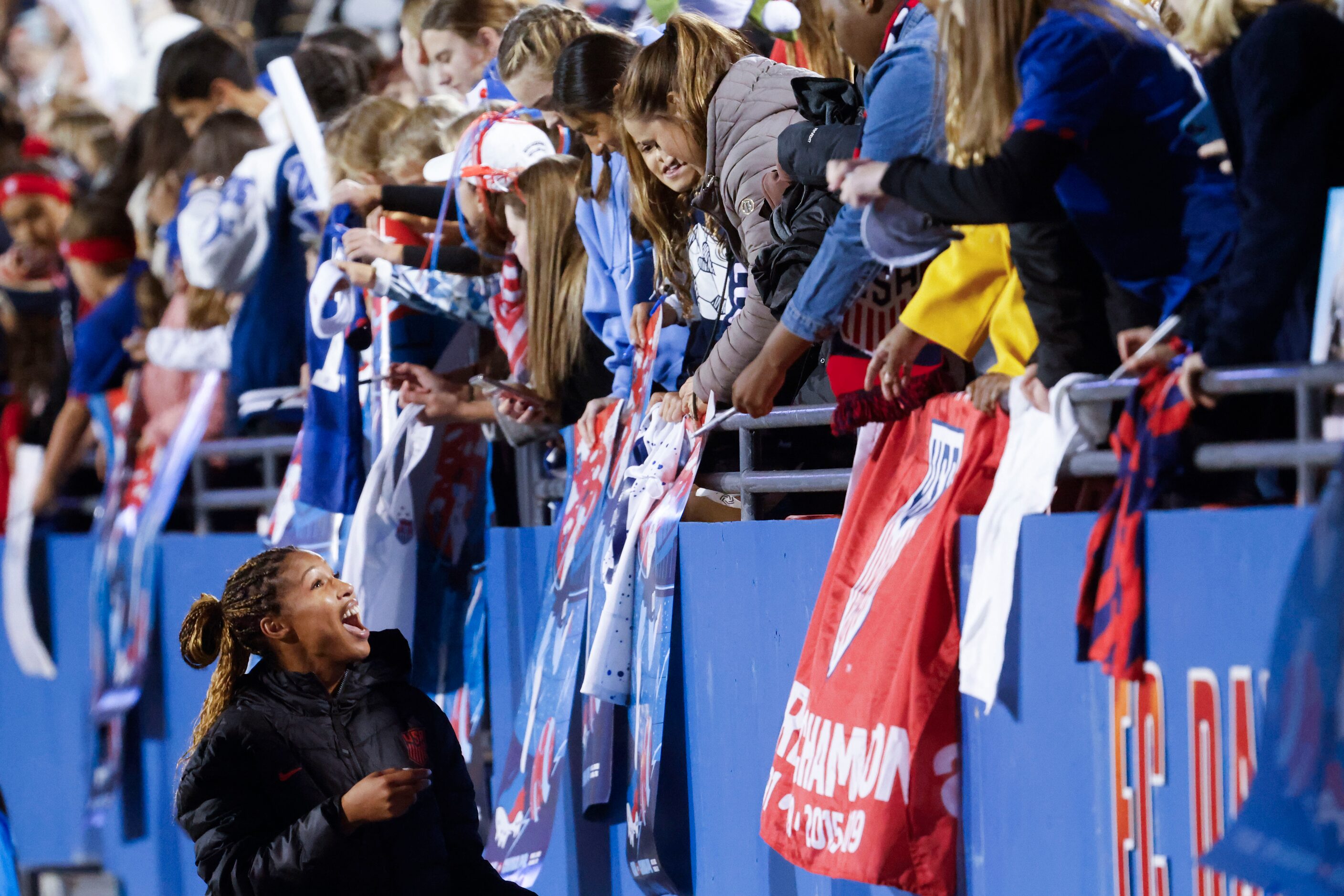 United States forward Midge Purce reacts to fans while signing autographs after a soccer...