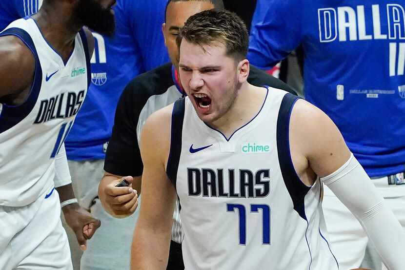 Dallas Mavericks guard Luka Doncic (77) celebrates with teammates after the final buzzer of...