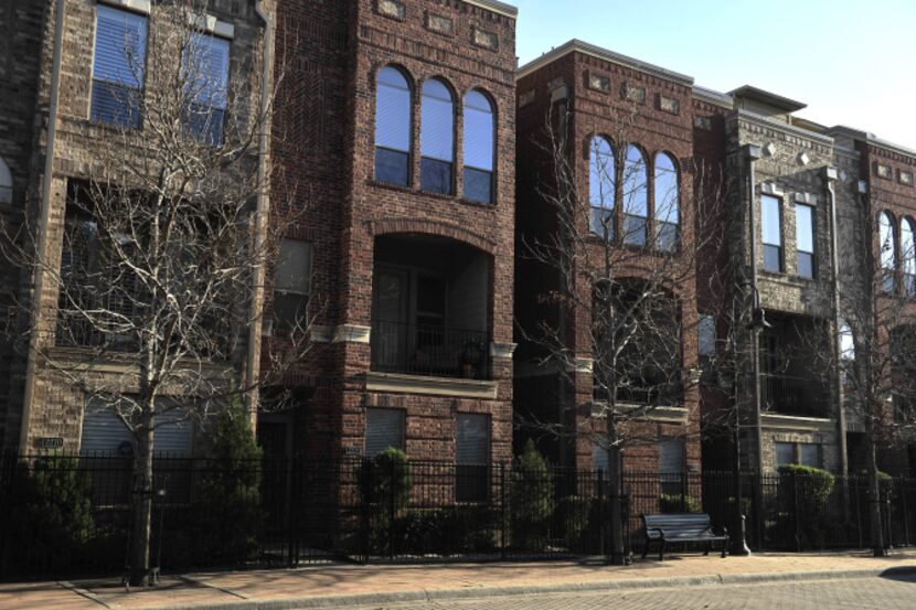 The facade of City View at Farmers Market town homes reflects the sunlight in the Dallas...