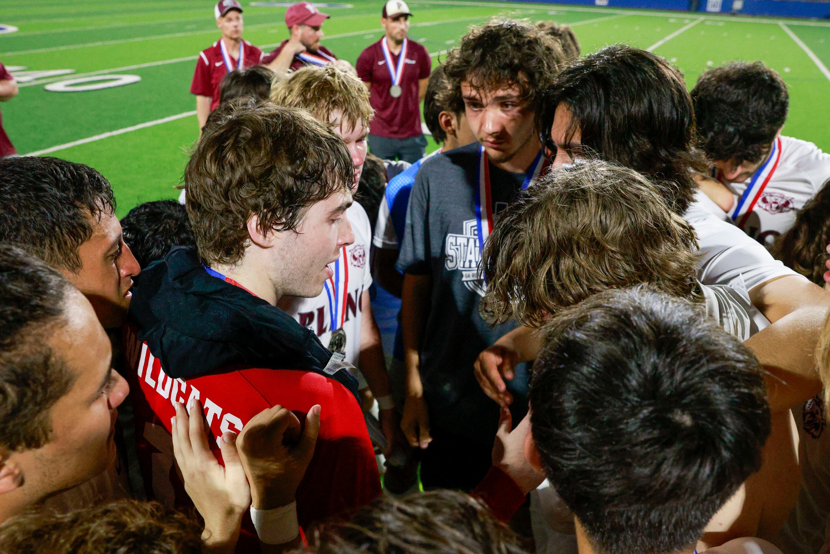 Plano goalkeeper Henry Huffstetler (center left) talks to his team after losing the Class 6A...