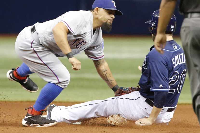 ST. PETERSBURG, FL - AUGUST 20:  Roughned Odor #12 of the Texas Rangers misses the tag on...