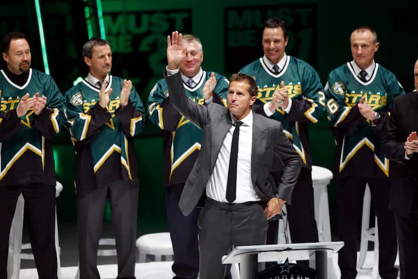 Mike Modano waves to the crowd during his jersey retirement ceremony at American Airlines...