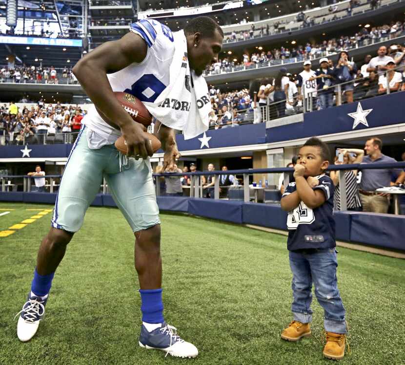 Dallas Cowboys wide receiver Dez Bryant (left) plays with his 3-year-old son, Dez Bryant,...