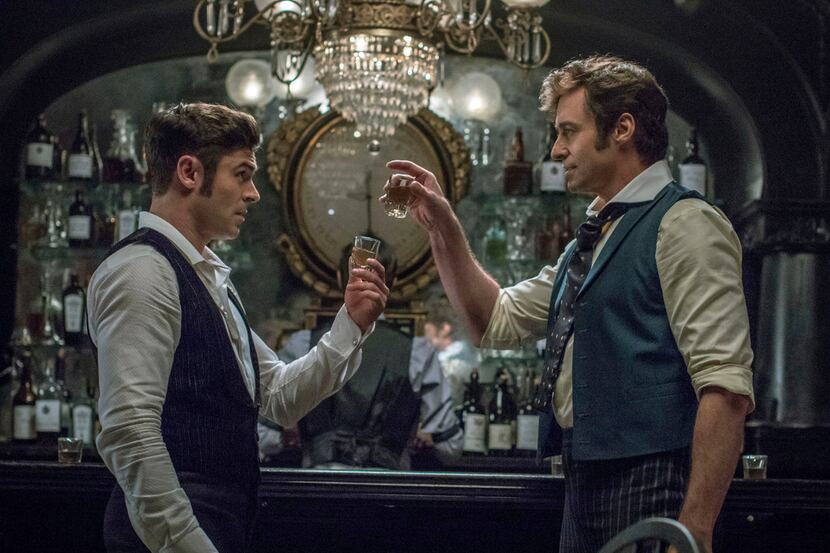 Zac Efron, left, and Hugh Jackman in a scene from "The Greatest Showman."