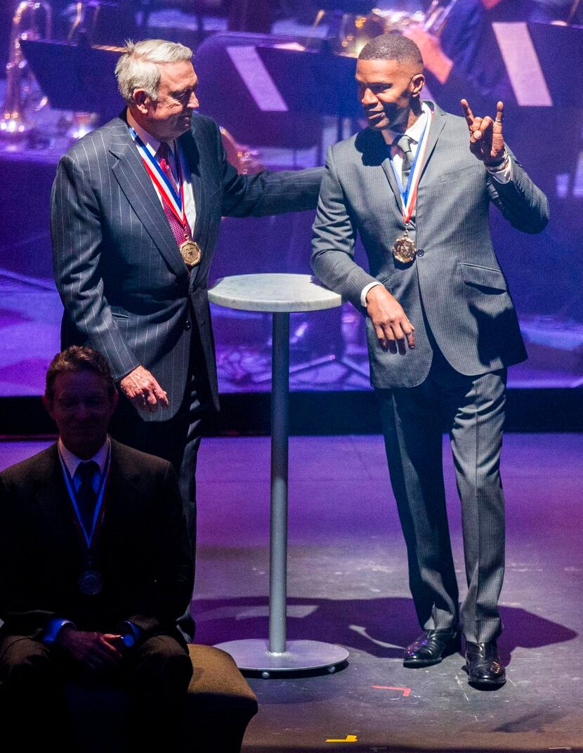 
Journalist Dan Rather, top left, actor Jamie Foxx, right, and other honorees take the stage...