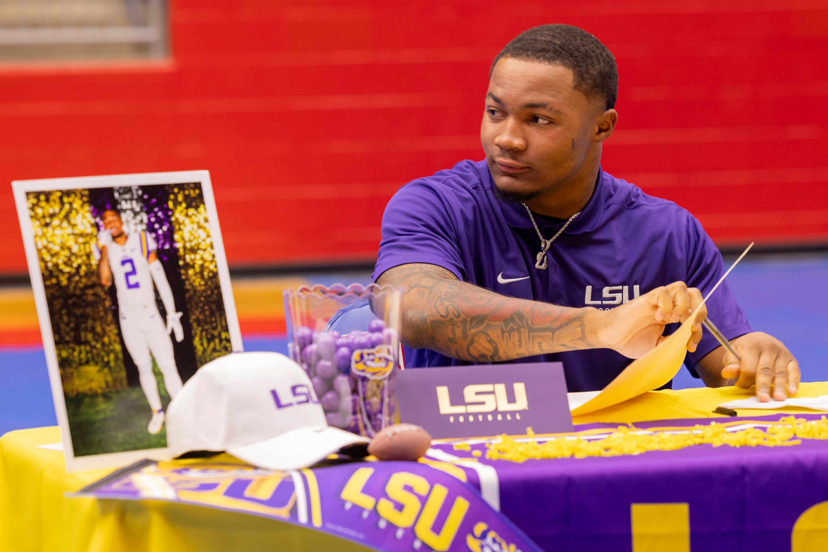 Running back Caden Durham closes his folder after signing his national letter of intent to...