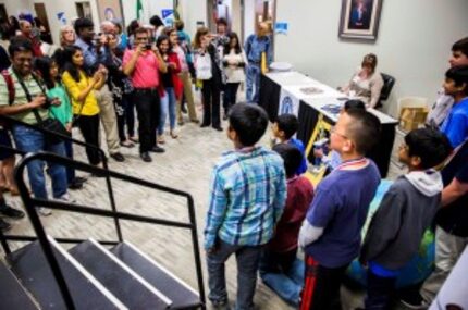  Parents take pictures of the top ten finalists during the National Geographic 2016 State...