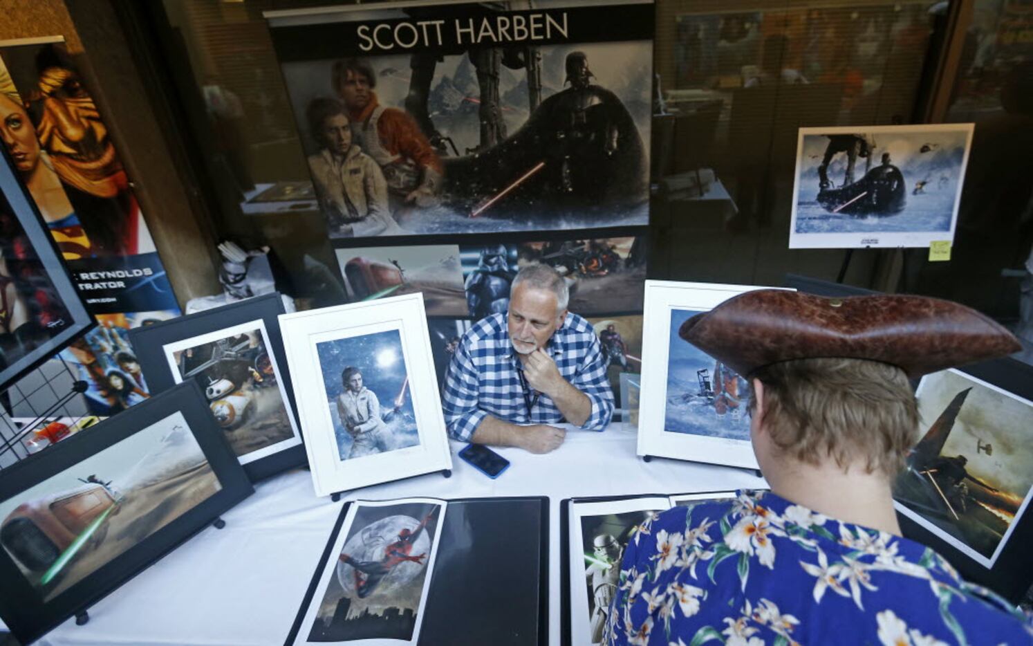 David Eaton (right) looks at artworks by Scott Harben during Dallas Comic Show at Richardson...