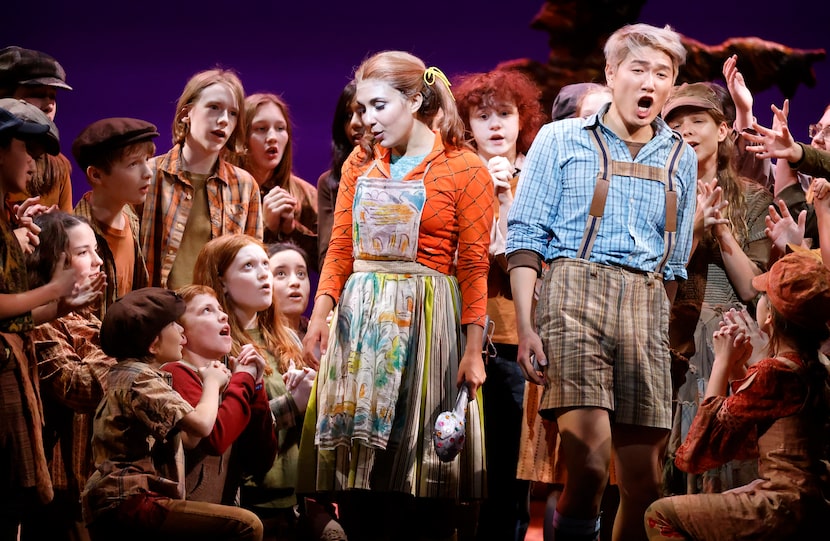 Hansel (Kangmin Justin Kim, right) and Gretel (Elena Villalón) sing with a cast of children...