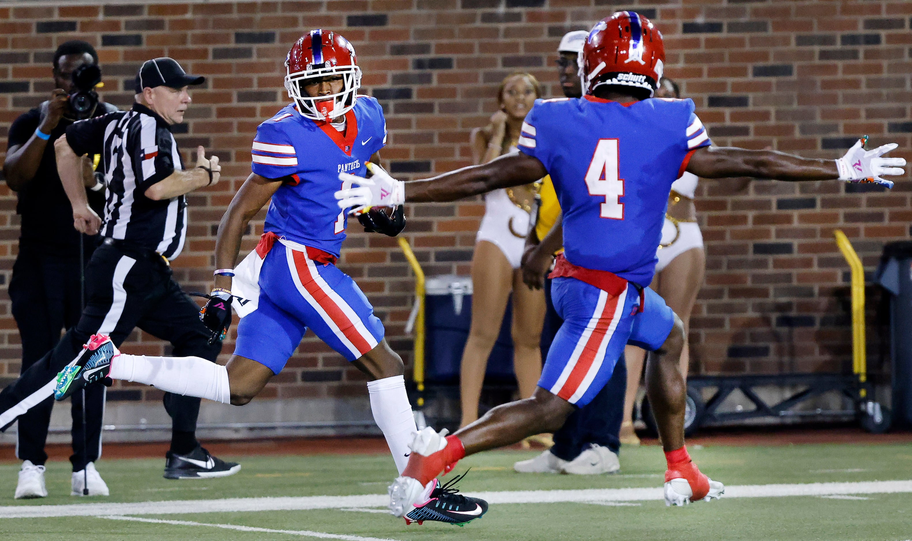 Duncanville wide receiver Dakorien Moore (1) looks over his shoulder as he carries the ball...