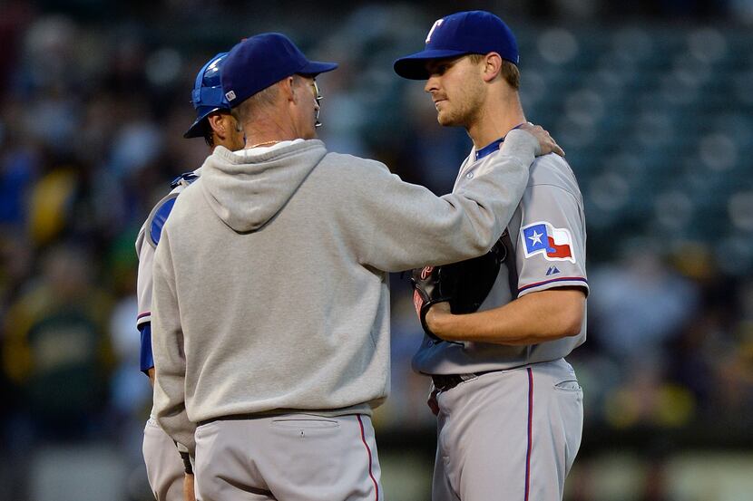OAKLAND, CA - MAY 13:  Pitching coach Mike Maddux #31 of the Texas Rangers comes out to talk...